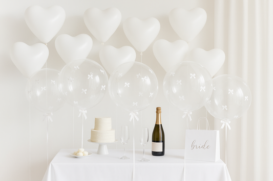 Large clear balloons with white bows at 