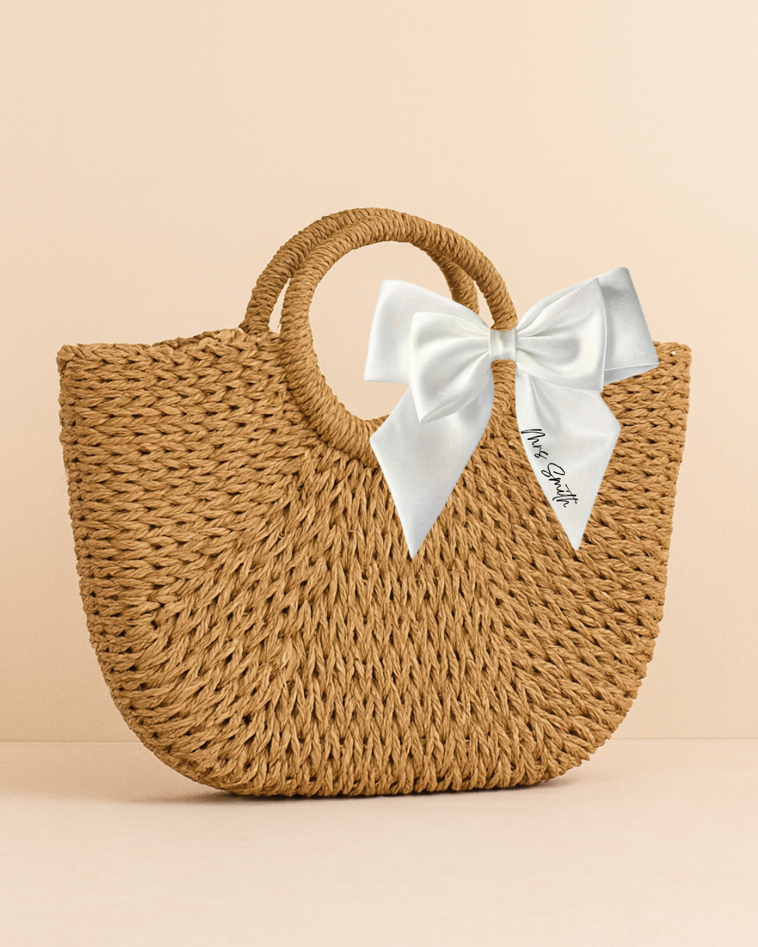 Woven handbag with a white bow on a beige background